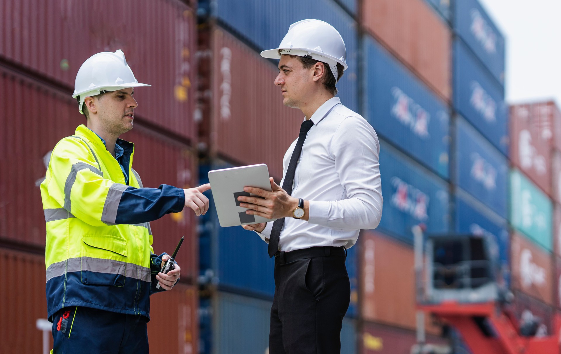 Dock workers inspecting container shipping in the distribution warehouse